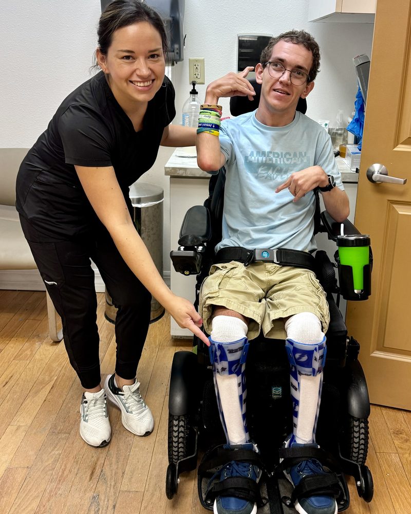 A Manifest clinician with a patient wearing custom bilateral ankle-foot orthoses (AFOs).