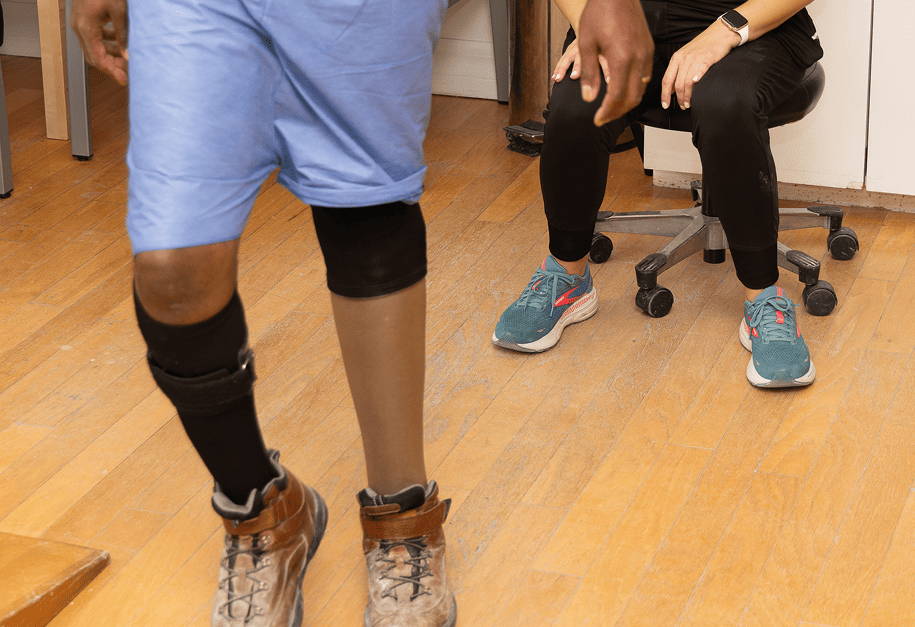 Patient with a leg orthosis being evaluated by a Manifest clinician.