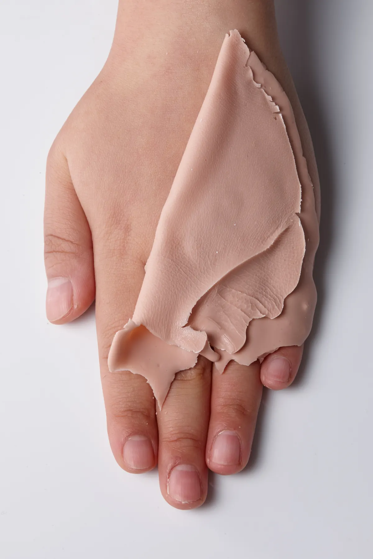Hand-painted silicone finger prosthesis.
